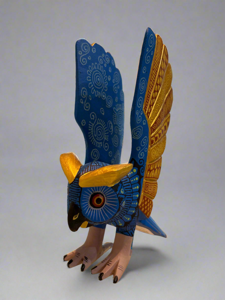 Decorative blue and gold owl sculpture .