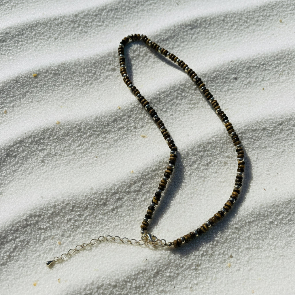 Necklace with beaded chain on a piece of paper