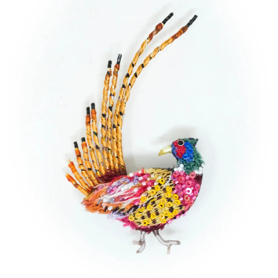 Colorful bird-shaped decorative item made from beads on a white background