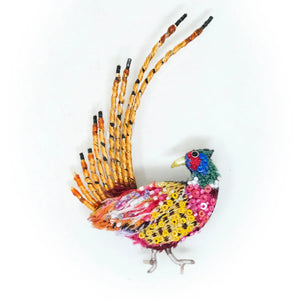 Colorful bird-shaped decorative item made from beads on a white background